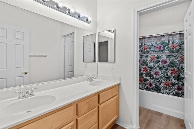 9011 Honeysuckle Ave, Hesperia, CA 92344 - bathroom featuring double vanity, wood finished floors, and shower / bath combo