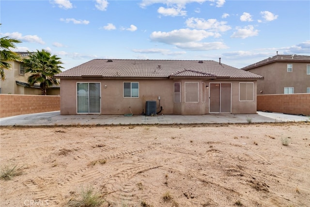 9011 Honeysuckle Ave, Hesperia, CA 92344 - rear view of property featuring stucco siding, central AC unit, a patio area, and a tile roof