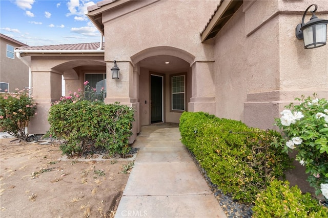 9011 Honeysuckle Ave, Hesperia, CA 92344 - doorway to property with stucco siding and a tiled roof