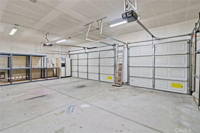 9011 Honeysuckle Ave, Hesperia, CA 92344 - garage with a garage door opener and white refrigerator with ice dispenser