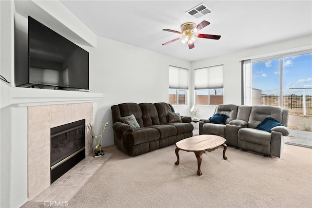 9011 Honeysuckle Ave, Hesperia, CA 92344 - carpeted living room featuring ceiling fan and a tiled fireplace