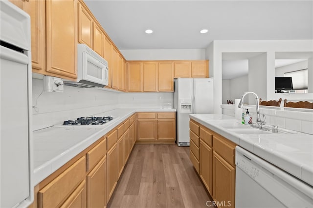 9011 Honeysuckle Ave, Hesperia, CA 92344 - kitchen featuring white appliances, a sink, light wood-type flooring, tile countertops, and recessed lighting