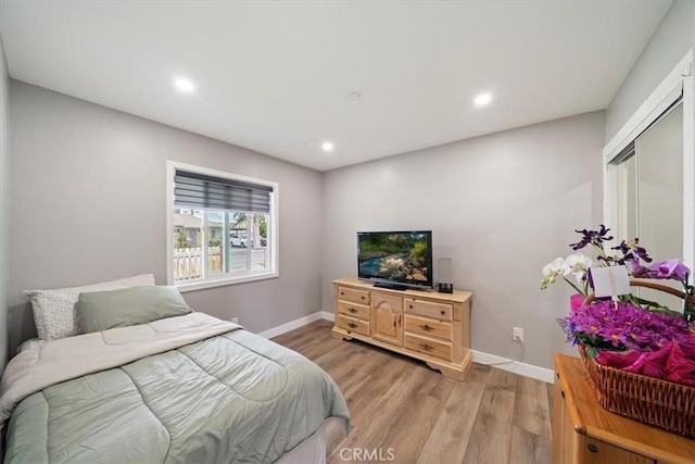 2329 Roxbury Dr, San Bernardino, CA 92404 - bedroom with light wood finished floors, baseboards, and recessed lighting