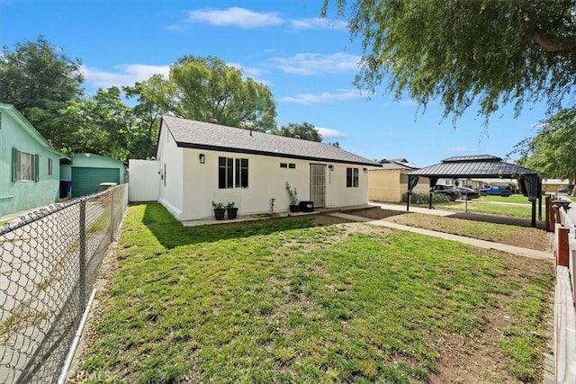 2329 Roxbury Dr, San Bernardino, CA 92404 - back of house with a gazebo and stucco siding