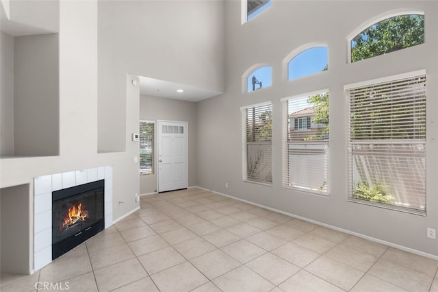 170 Valley View Ter, Mission Viejo, CA 92692 - unfurnished living room with a high ceiling, a tiled fireplace, tile patterned floors, and baseboards