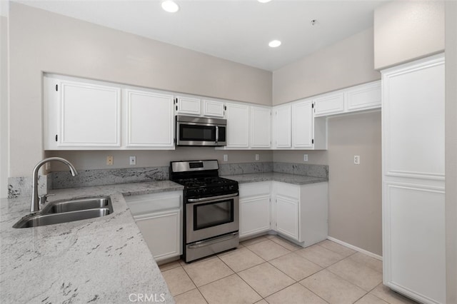 170 Valley View Ter, Mission Viejo, CA 92692 - kitchen with appliances with stainless steel finishes, a sink, white cabinets, light stone counters, and light tile patterned floors