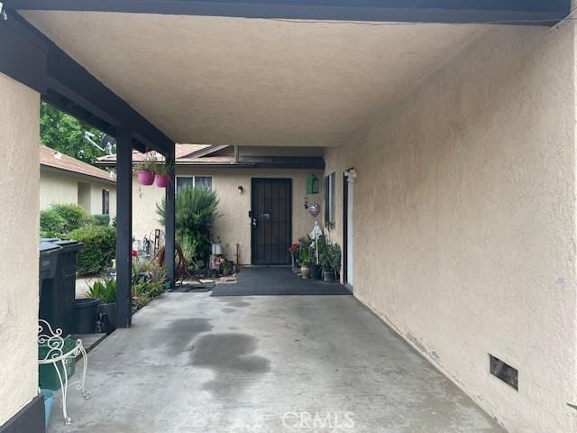 1354 Bushy Tail Trl, San Jacinto, CA 92583 - property entrance with stucco siding, crawl space, and an attached carport