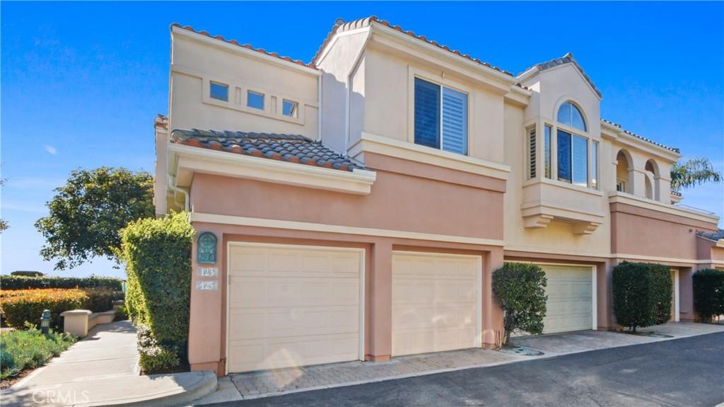 123 Costa Brava, Laguna Niguel, CA 92677 - view of front of house with an attached garage, a tiled roof, and stucco siding