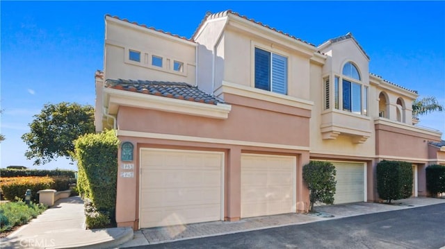 123 Costa Brava, Laguna Niguel, CA 92677 - view of front of house with an attached garage, a tiled roof, and stucco siding