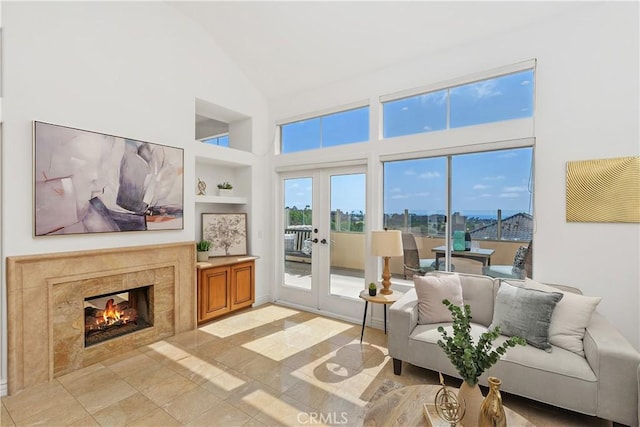 123 Costa Brava, Laguna Niguel, CA 92677 - living area featuring built in shelves, high vaulted ceiling, french doors, and a tiled fireplace