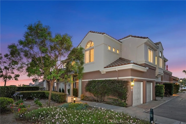 123 Costa Brava, Laguna Niguel, CA 92677 - view of front of home featuring an attached garage, a tile roof, and stucco siding