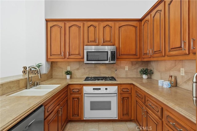 123 Costa Brava, Laguna Niguel, CA 92677 - kitchen with stainless steel appliances, a sink, light countertops, and brown cabinetry