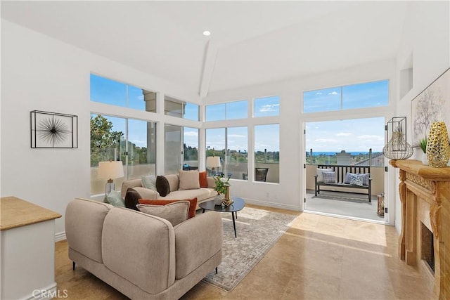 123 Costa Brava, Laguna Niguel, CA 92677 - tiled living area featuring healthy amount of natural light, recessed lighting, baseboards, a high ceiling, and a fireplace