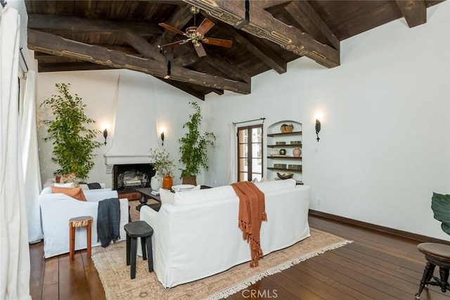 living room with wood ceiling, wood-type flooring, a large fireplace, a ceiling fan, and baseboards