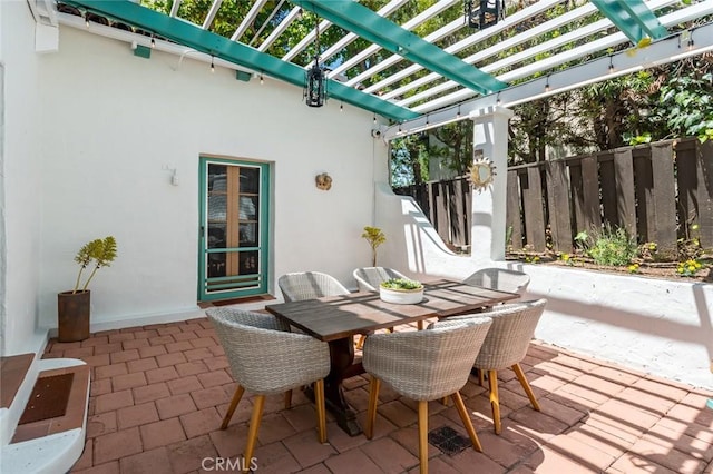view of patio with a pergola, outdoor dining space, and fence