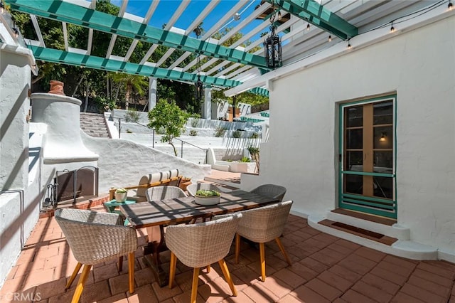 view of patio / terrace with a pergola and outdoor dining area