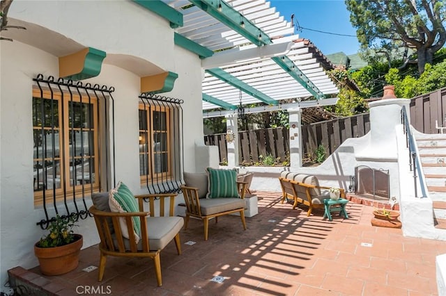 view of patio / terrace with a pergola and fence