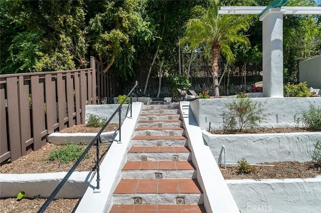 view of yard with fence and stairway
