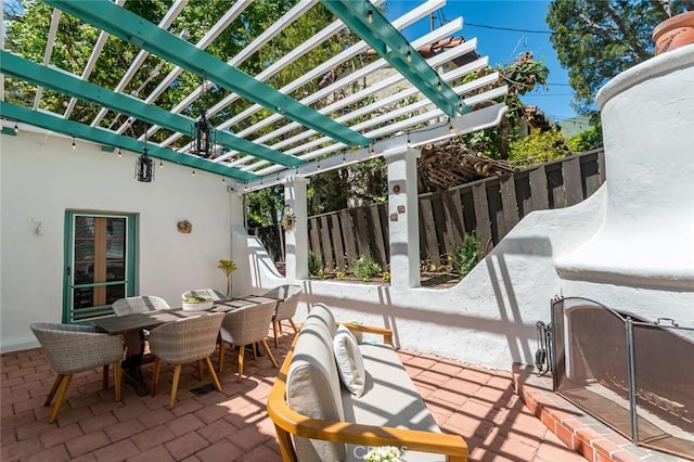 view of patio / terrace with a pergola, fence, and outdoor dining space