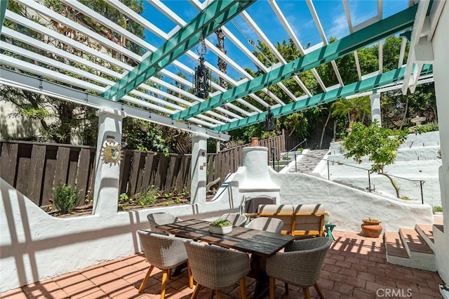 view of patio with outdoor dining area, fence, and a pergola