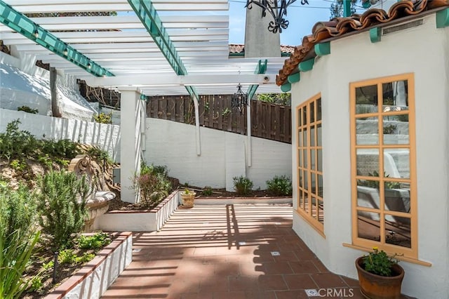 view of patio featuring fence and a pergola