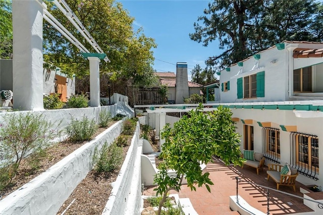 view of property's community with fence and a patio