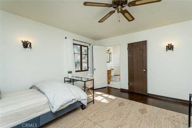 bedroom with wood finished floors, connected bathroom, and a ceiling fan