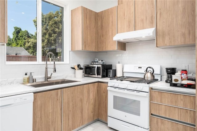 14027 Wyandotte St, Van Nuys, CA 91405 - kitchen with white appliances, under cabinet range hood, a sink, and modern cabinets