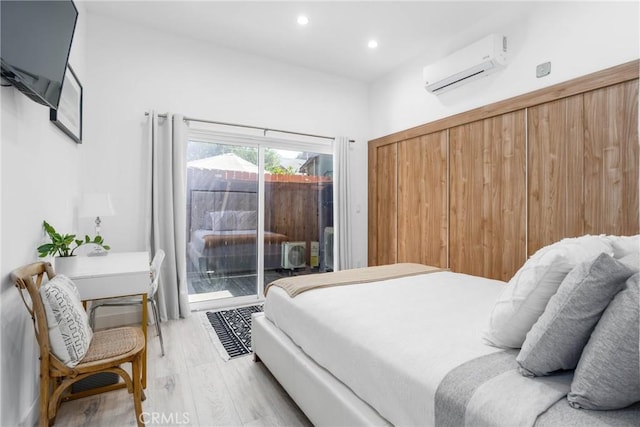 14027 Wyandotte St, Van Nuys, CA 91405 - bedroom featuring a wall mounted AC, access to exterior, light wood finished floors, and recessed lighting