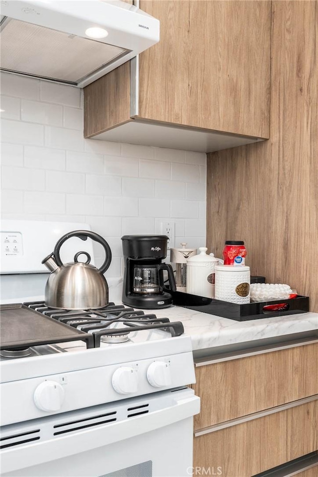 14027 Wyandotte St, Van Nuys, CA 91405 - kitchen with range hood, white range with gas cooktop, backsplash, and modern cabinets