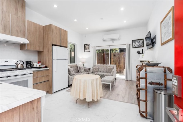 14027 Wyandotte St, Van Nuys, CA 91405 - kitchen featuring white appliances, a wall mounted AC, open floor plan, recessed lighting, and under cabinet range hood
