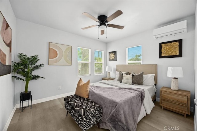 2461 Saint Pierre Ave, Altadena, CA 91001 - bedroom featuring a wall mounted AC, wood finished floors, baseboards, and a ceiling fan