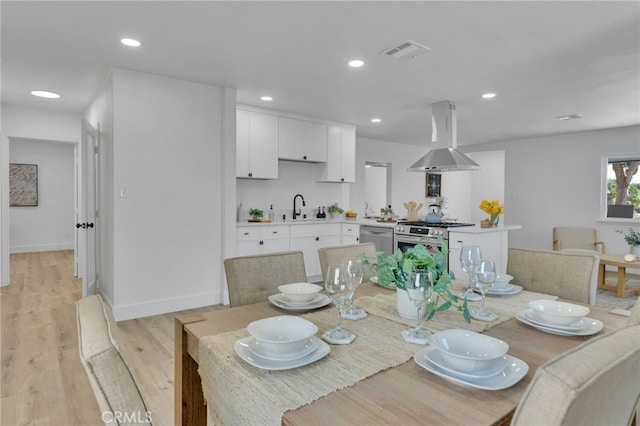8332 Cherimoya Ave, Fontana, CA 92335 - dining room with light wood-style floors, recessed lighting, and baseboards