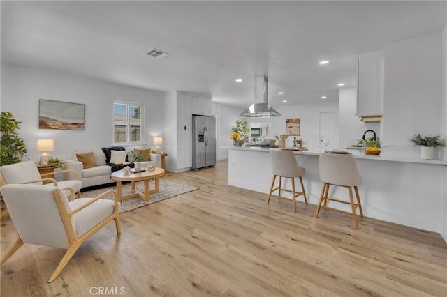 8332 Cherimoya Ave, Fontana, CA 92335 - living room with light wood-style floors and recessed lighting
