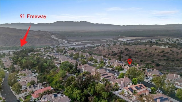 1551 Dominguez Ranch Rd, Corona, CA 92882 - aerial overview of property's location featuring a mountain backdrop and nearby suburban area