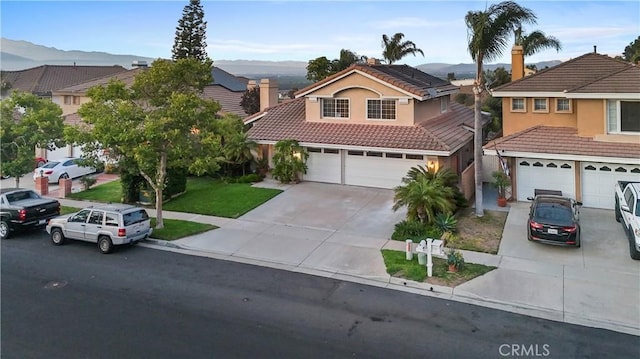 1551 Dominguez Ranch Rd, Corona, CA 92882 - traditional-style home with concrete driveway, an attached garage, a tile roof, and stucco siding