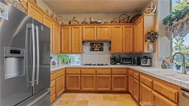 1551 Dominguez Ranch Rd, Corona, CA 92882 - kitchen with appliances with stainless steel finishes, decorative backsplash, tile counters, and brown cabinets