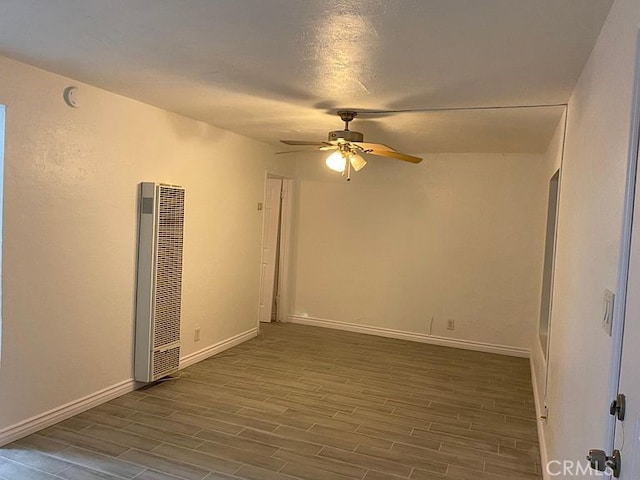 3352 Franklin Ave, Riverside, CA 92507 - empty room featuring a heating unit, ceiling fan, wood finished floors, and baseboards