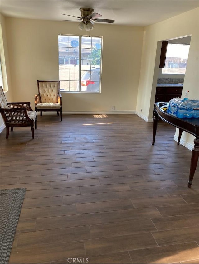 3352 Franklin Ave, Riverside, CA 92507 - living area with dark wood-type flooring, a ceiling fan, and baseboards