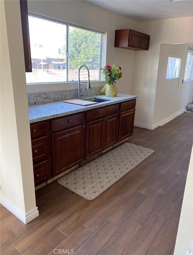 3352 Franklin Ave, Riverside, CA 92507 - kitchen featuring a sink, dark wood-type flooring, baseboards, and healthy amount of natural light