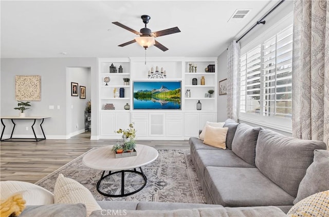 25303 Water Wheel Ct, Menifee, CA 92584 - living room with ceiling fan, wood finished floors, baseboards, and built in shelves