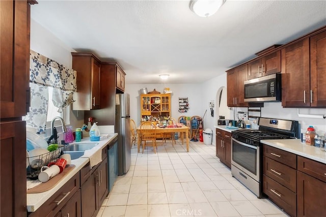 260 Pierce Ave, Barstow, CA 92311 - kitchen with appliances with stainless steel finishes, a sink, and light countertops