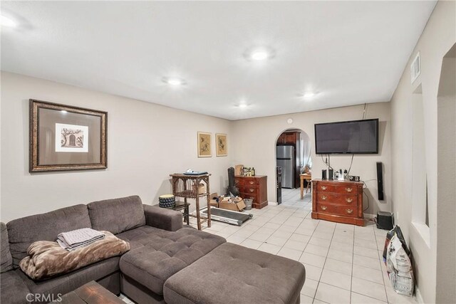 260 Pierce Ave, Barstow, CA 92311 - living room with arched walkways, light tile patterned floors, recessed lighting, and baseboards