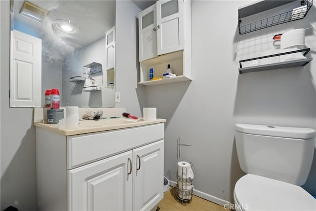 12737 Cometa Ave, San Fernando, CA 91340 - half bathroom with toilet, vanity, wood finished floors, and baseboards