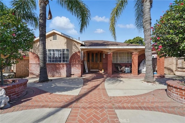 12737 Cometa Ave, San Fernando, CA 91340 - view of front of home with stucco siding, brick siding, and a patio