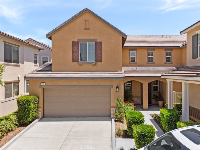 3170 E Painted Crescent St, Ontario, CA 91762 - multi unit property with an attached garage, concrete driveway, stucco siding, and a tile roof