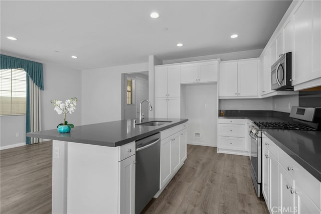 3170 E Painted Crescent St, Ontario, CA 91762 - kitchen with appliances with stainless steel finishes, dark countertops, recessed lighting, a sink, and wood finished floors