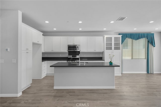 3170 E Painted Crescent St, Ontario, CA 91762 - kitchen featuring appliances with stainless steel finishes, dark countertops, a sink, white cabinetry, and recessed lighting