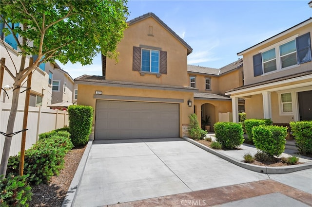 3170 E Painted Crescent St, Ontario, CA 91762 - view of front of property with stucco siding, a garage, and driveway