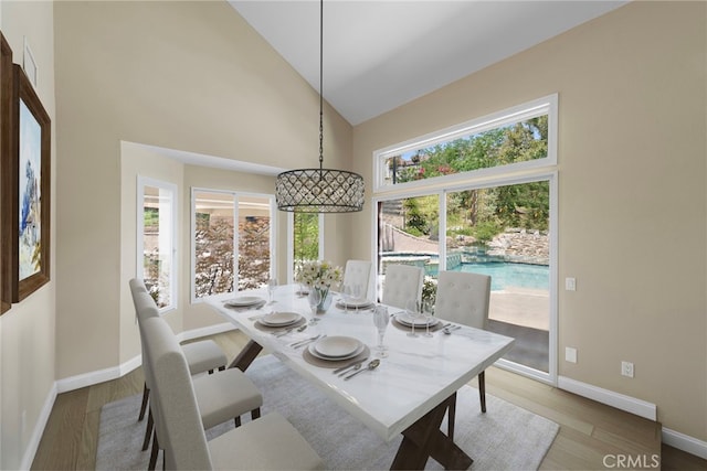 26021 Flintlock Ln, Laguna Hills, CA 92653 - dining room featuring high vaulted ceiling, baseboards, and wood finished floors